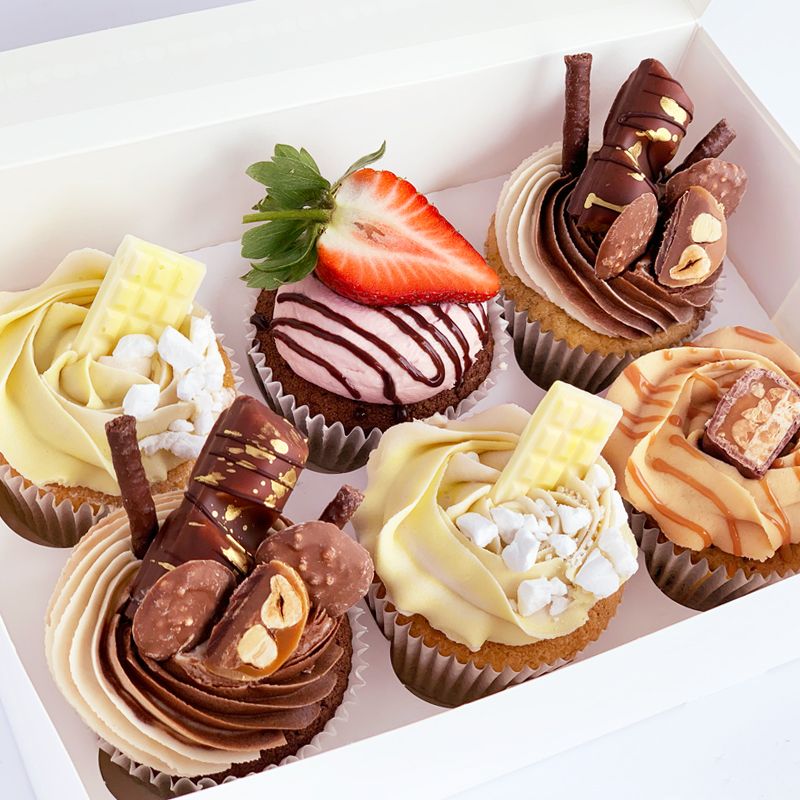 Founder of Our Sweet Zylen smiling while decorating a cake