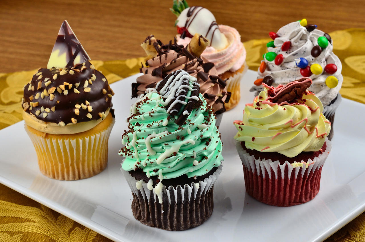 A variety of beautifully frosted cupcakes on a platter